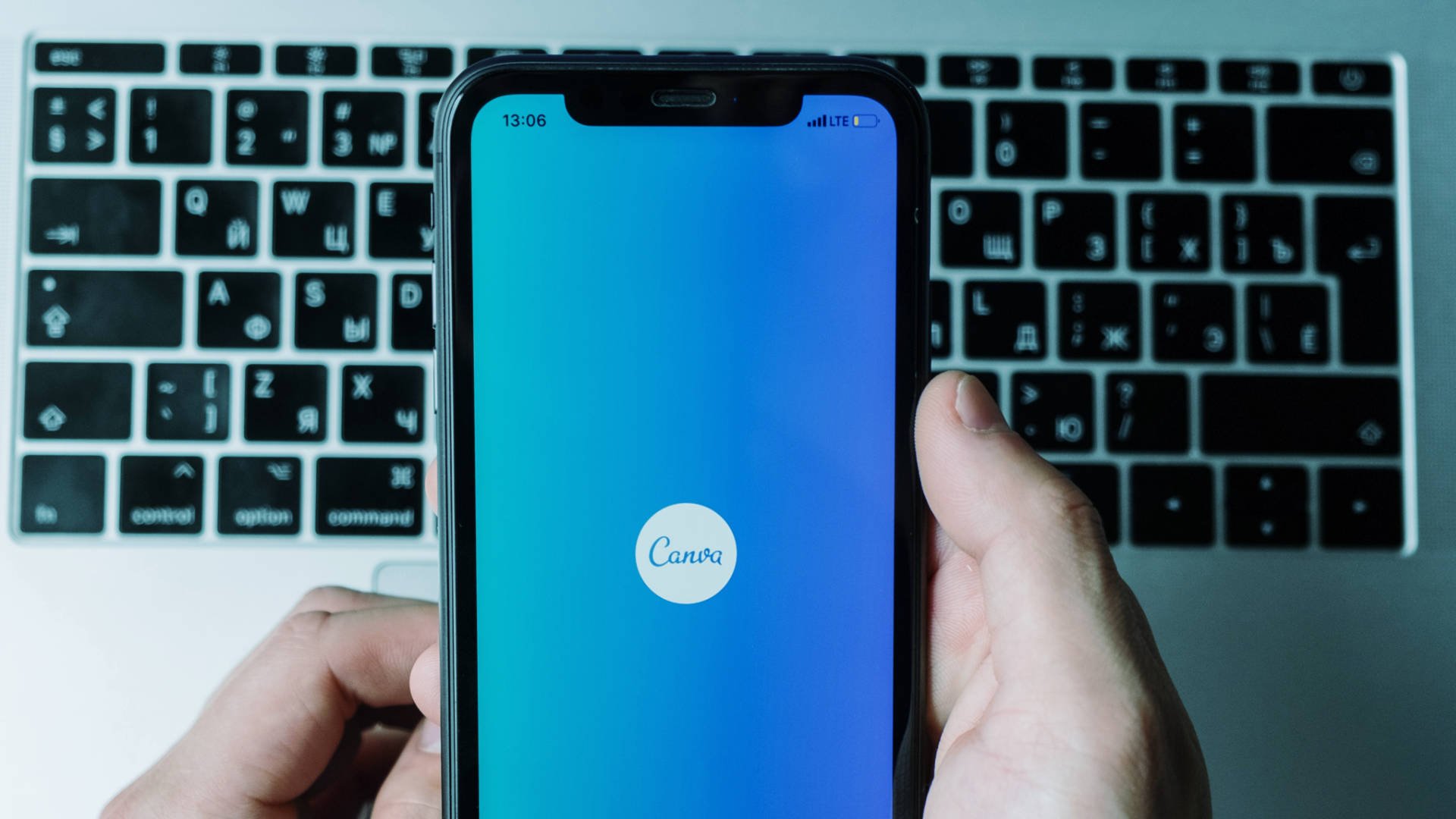 Phone displaying Canva Splashscreen, Is Canva Good For Graphics Design?